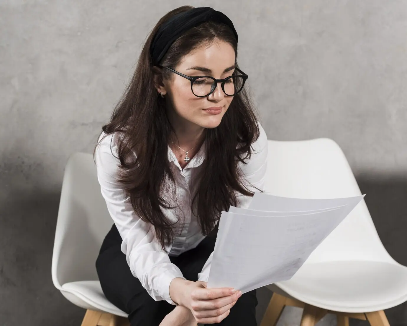Before attending a job interview, a woman reads her resume.