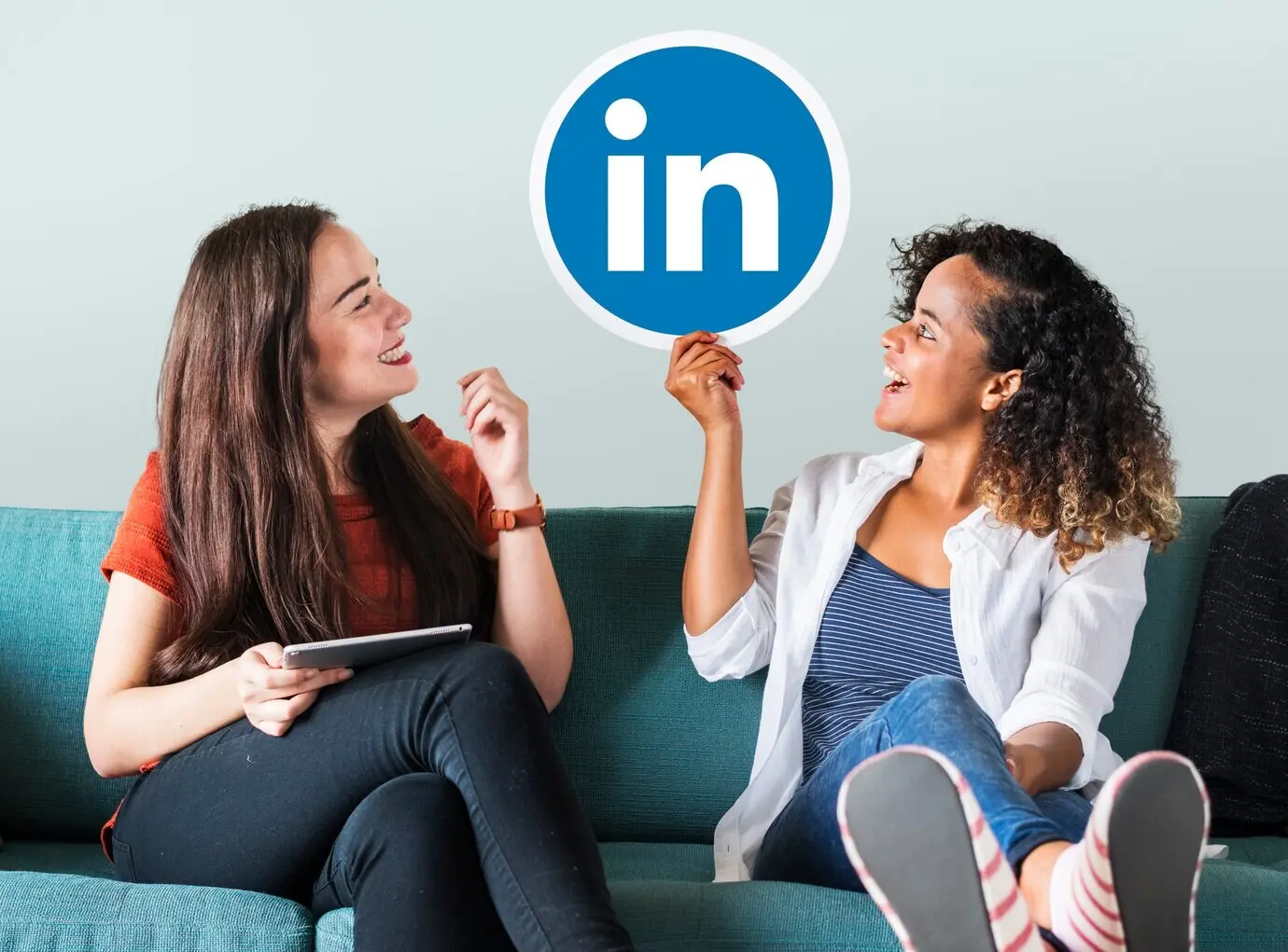 Women holding a logo for LinkedIn