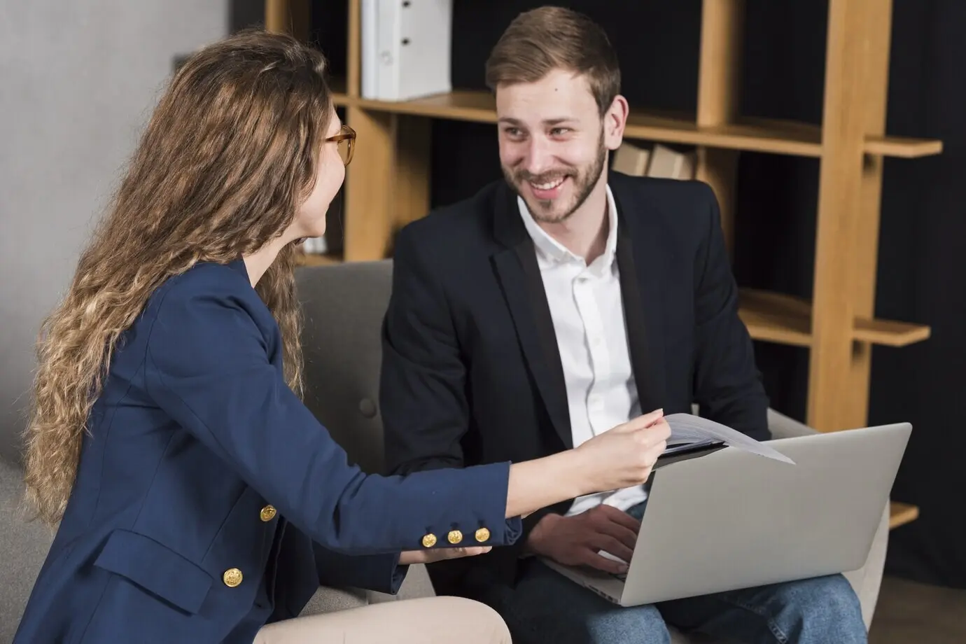 A woman is being interviewed by a man for a job position.